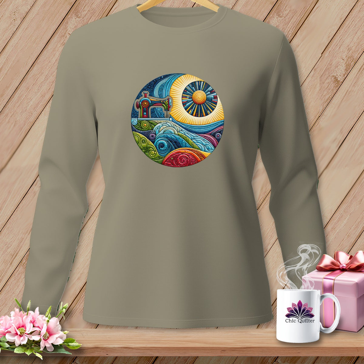 T-shirt with circular graphic of sewing machine, sun, and colorful waves.