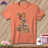 Orange t-shirt with a squirrel sitting on a stack of fabric quilts.