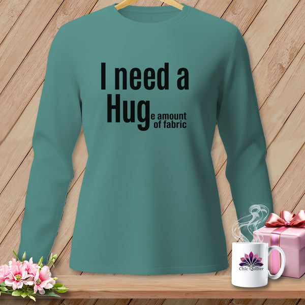 Teal long-sleeve shirt with black text "I need a Hug... the amount of fabric".