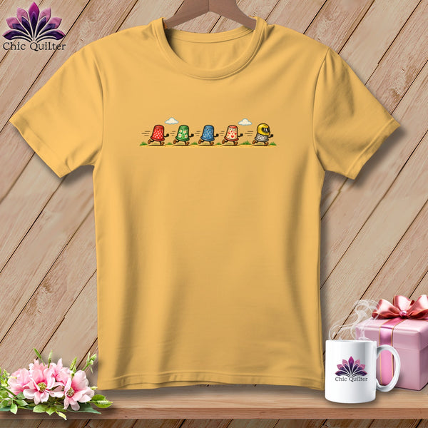 Gold crewneck t-shirt featuring a graphic of five running thimbles with arms and legs.