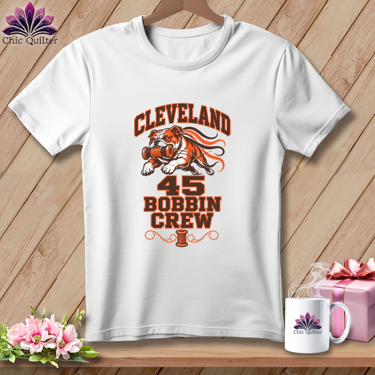 A white t-shirt features a Cleveland 45 Bobbin Crew graphic with a bulldog holding a spool of thread.
