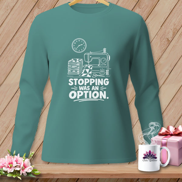 Teal long-sleeve shirt with sewing machine graphic and "Stopping Was An Option" text.