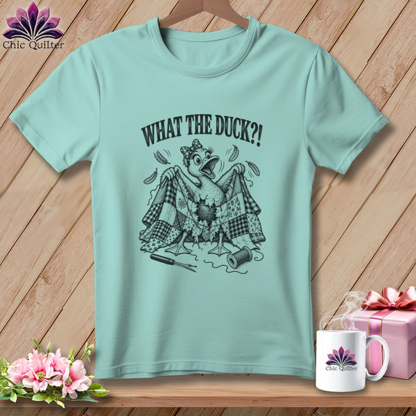Light blue t-shirt featuring a cartoon duck holding a patchwork quilt and the text WHAT THE DUCK?!