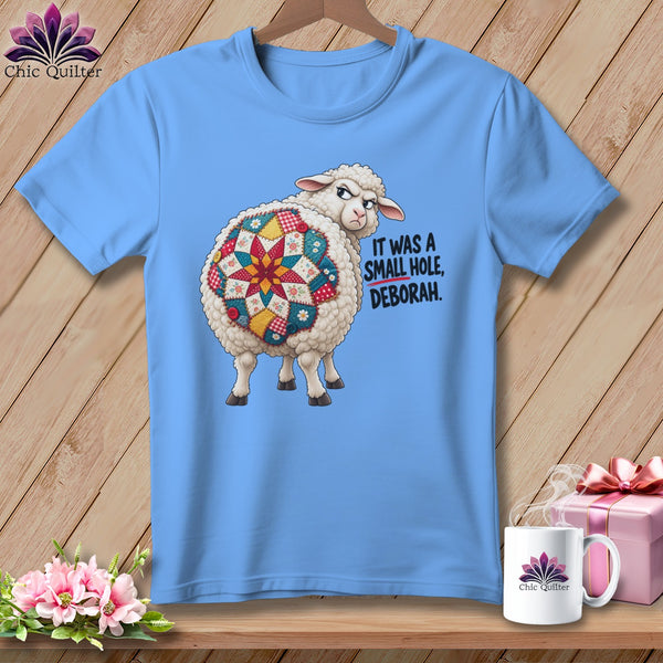 Blue t-shirt with a sheep with a quilted backside and text "It was a small hole, Deborah."
