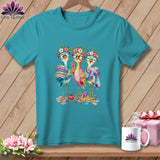 Teal crewneck t-shirt featuring a cartoon graphic of three colorful birds sewing and quilting.