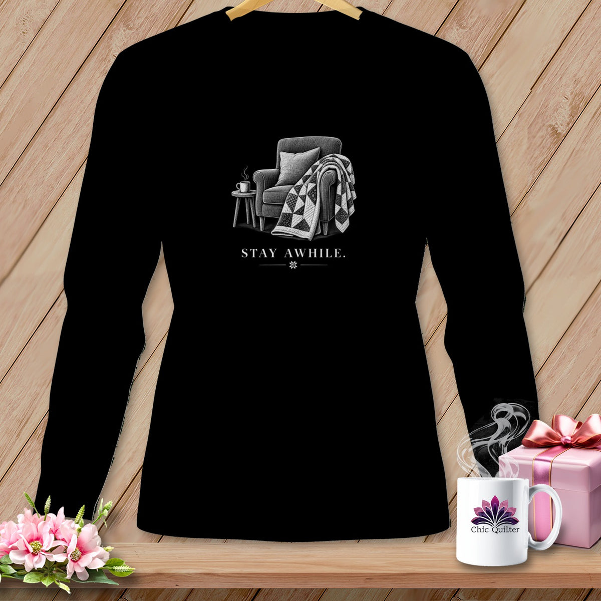 Black long-sleeve shirt with a vintage armchair, quilt, and coffee cup graphic.