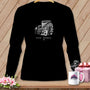 Black long-sleeve shirt with a vintage armchair, quilt, and coffee cup graphic.