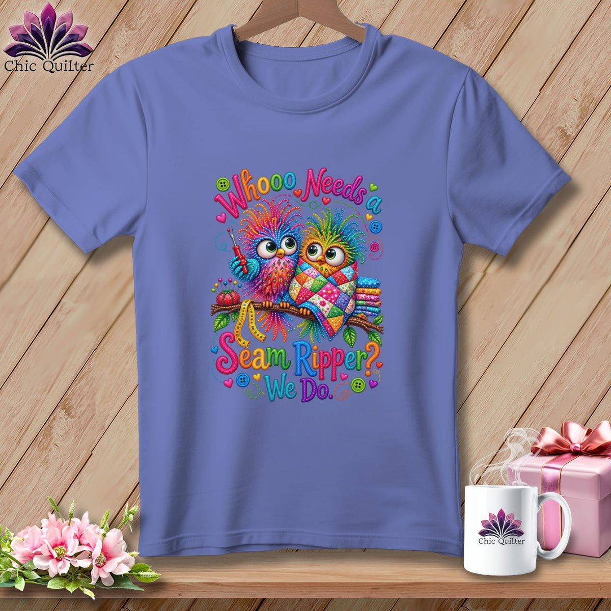 Purple short-sleeved t-shirt featuring a colorful graphic of two owls and the text Whooo Needs a Seam Ripper? We Do.
