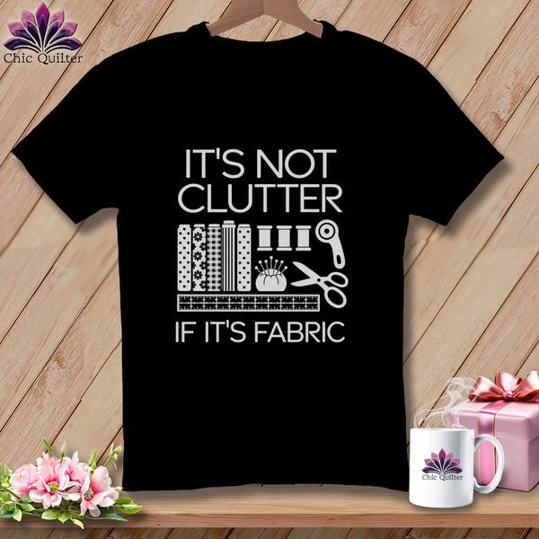 Black t-shirt with "It's not clutter if it's fabric" and sewing graphic.