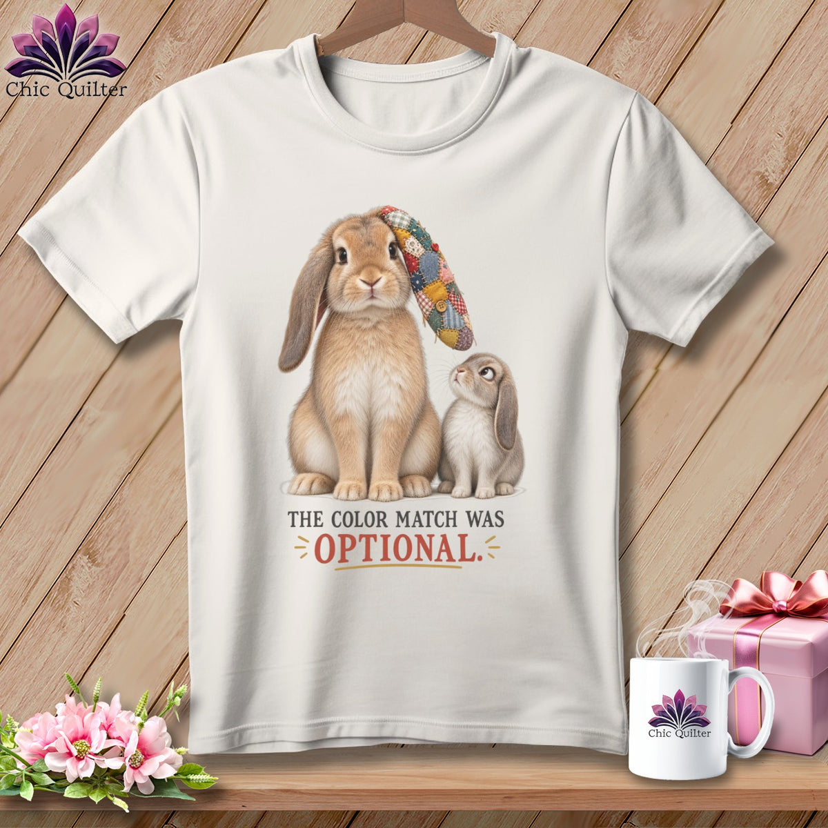 White t-shirt with two bunnies, one wearing a patchwork hat, and text "The color match was OPTIONAL."