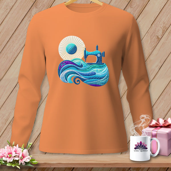 Orange long-sleeve shirt with a blue sewing machine and waves graphic.