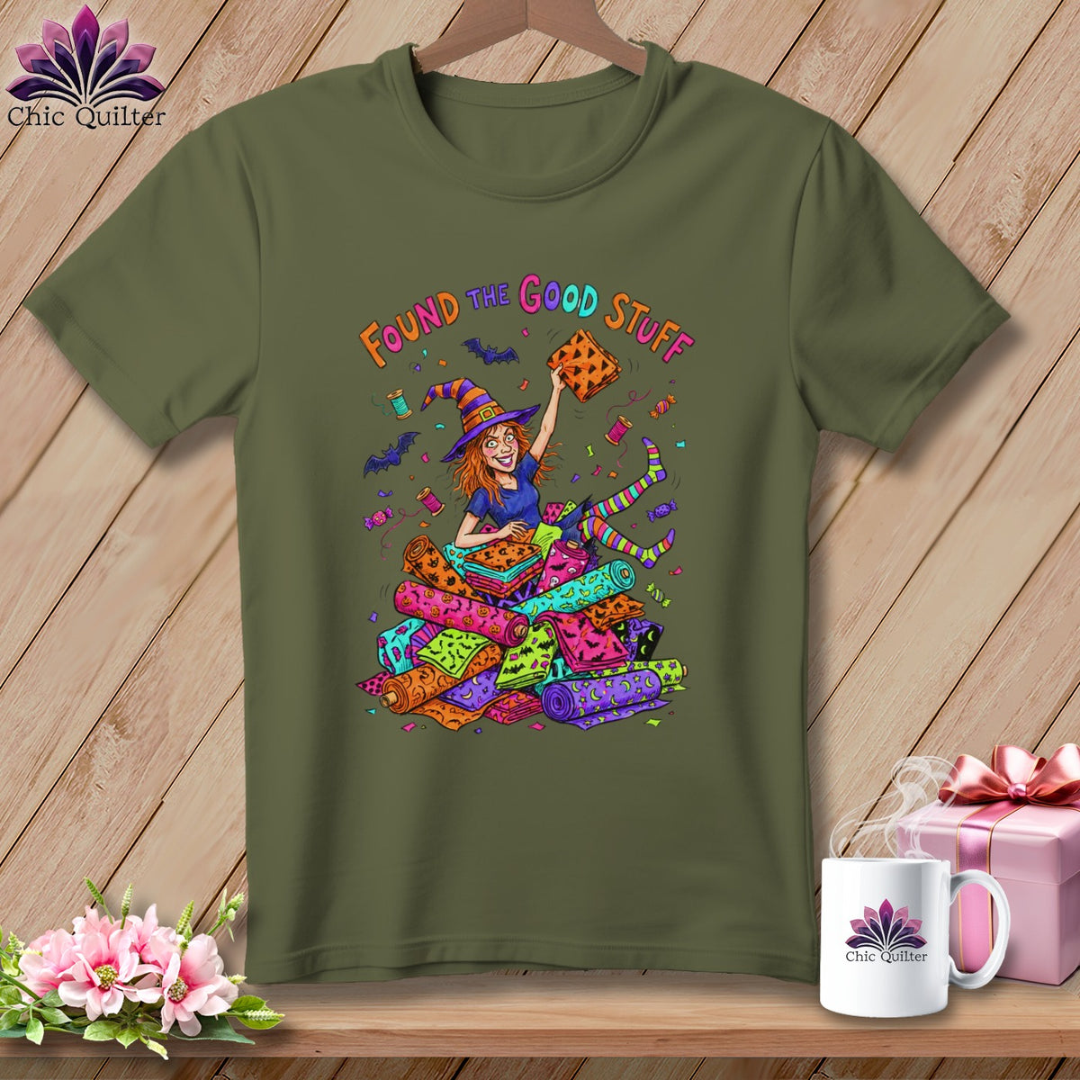 Green t-shirt with a cartoon witch holding fabric and the text "Found the Good Stuff".