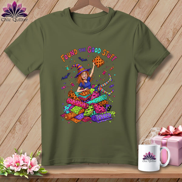 Green t-shirt with a cartoon witch holding fabric and the text "Found the Good Stuff".