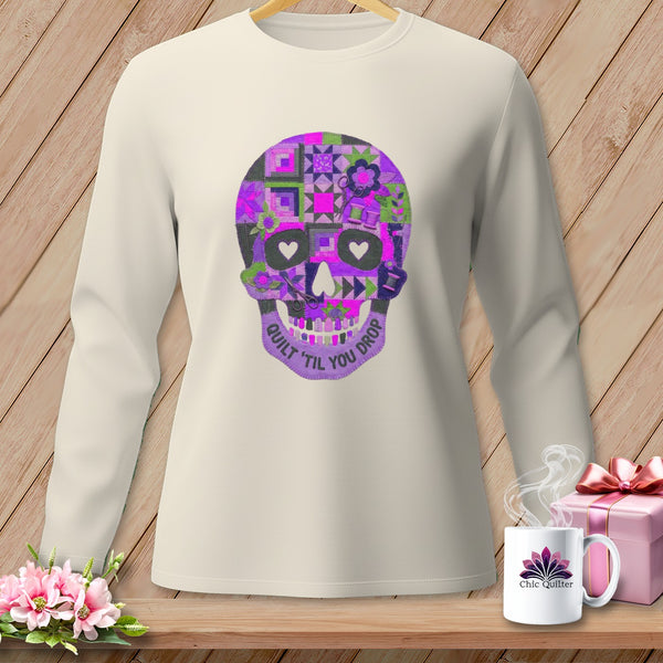 Cream long-sleeve shirt with a purple quilted skull graphic and "Quilt 'til You Drop" text.