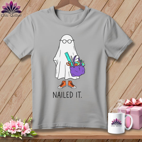Gray t-shirt with cartoon ghost holding sewing supplies and text "NAILED IT."