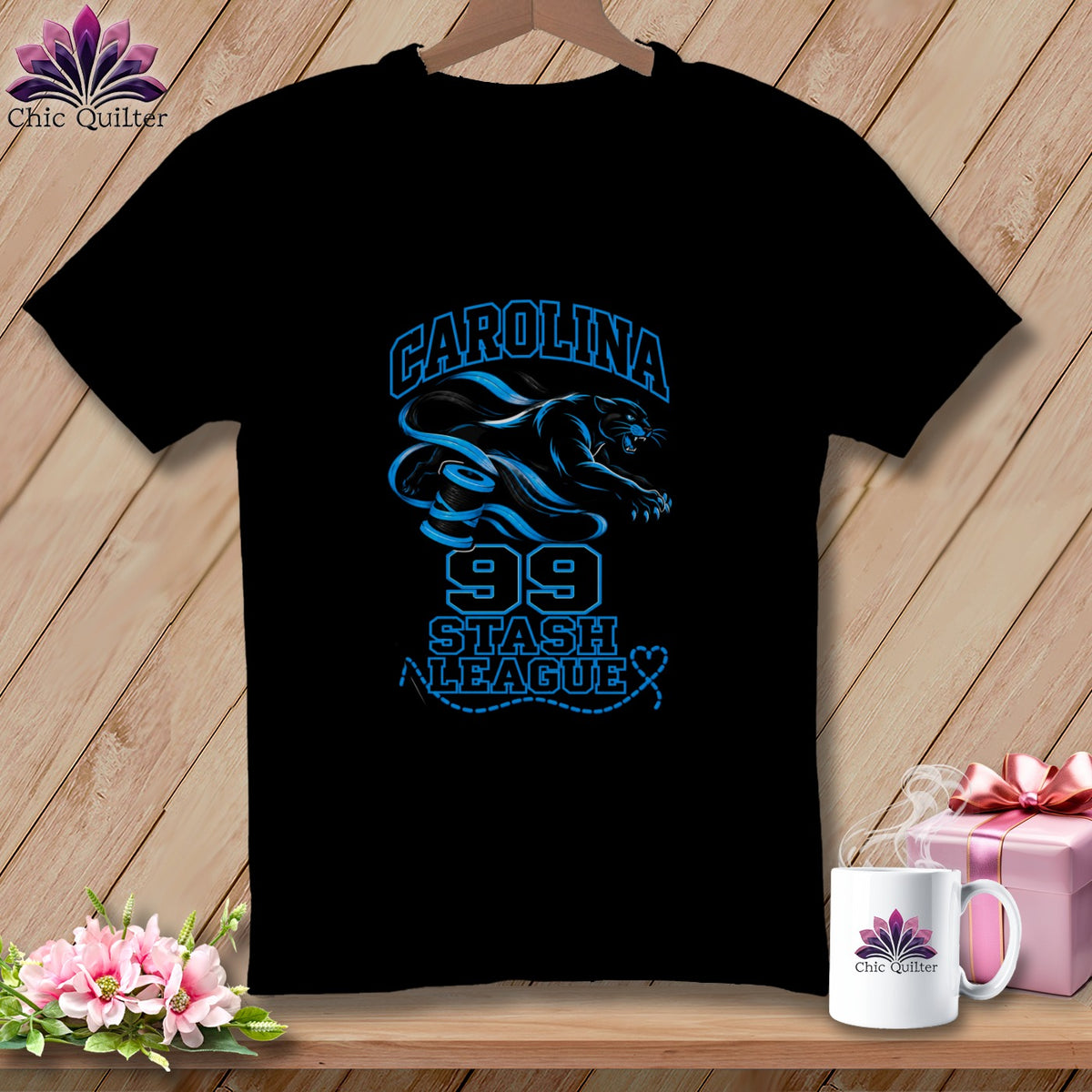 Black t-shirt featuring blue text reading "Carolina Stash League 99" alongside a leaping panther and spool graphic.