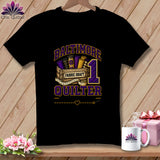 A black t-shirt features a graphic with the text Baltimore Quilter, a wooden crate of fabric bolts, a measuring tape, and the number one in purple and gold.