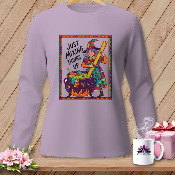 Long sleeve shirt with witch stirring cauldron and text "JUST MIXING THINGS UP".