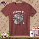 A dark red t-shirt printed with a peacock graphic and the white text, OH, PLUCK OFF!