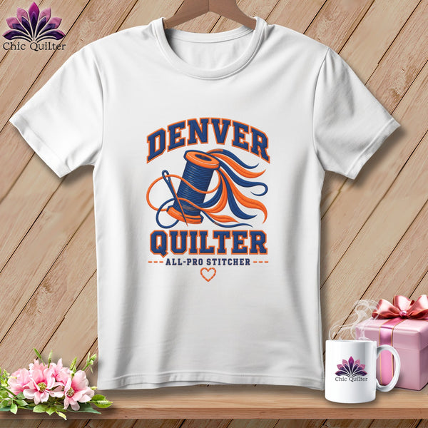 A white t-shirt features a Denver Quilter graphic with a spool of thread and a needle.