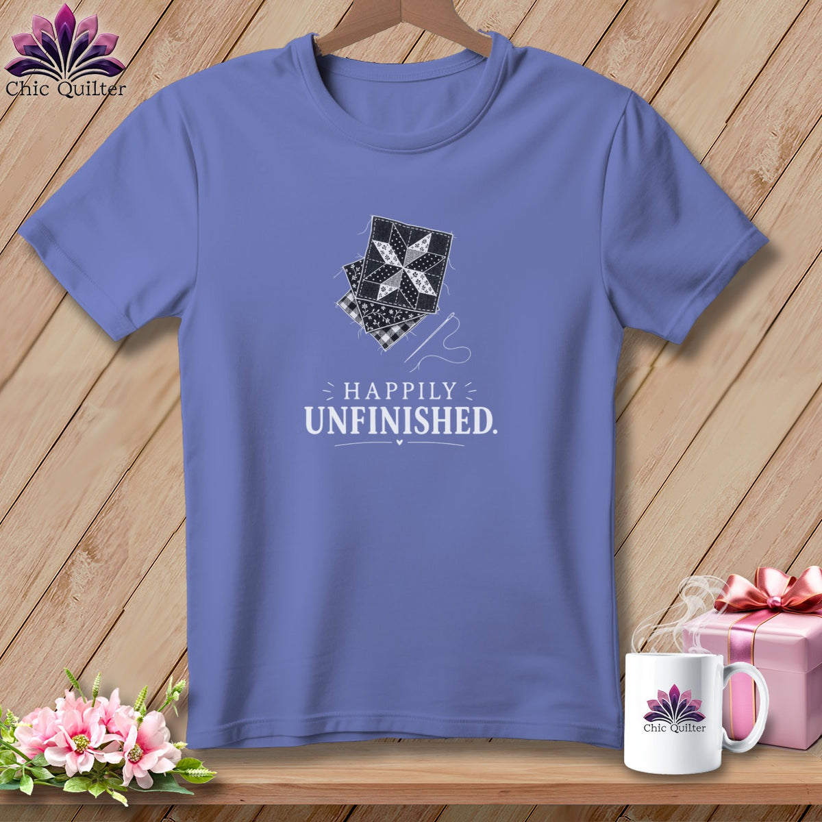 Purple t-shirt with quilting block graphic and "Happily Unfinished" text.