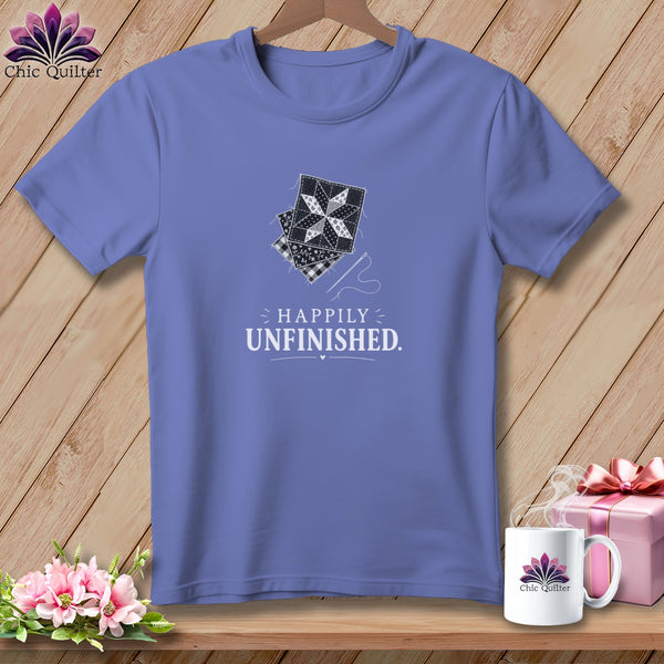 Purple t-shirt with quilting block graphic and "Happily Unfinished" text.