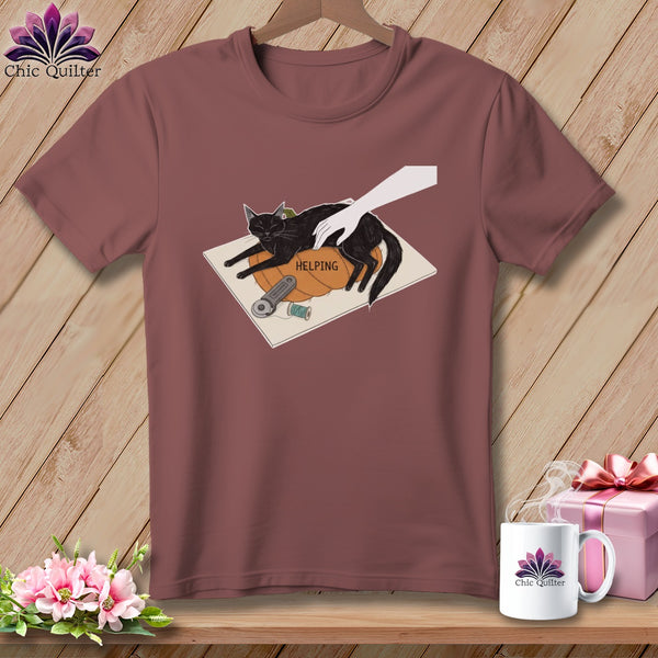 Black cat resting on pumpkin with text "HELPING" and sewing supplies.