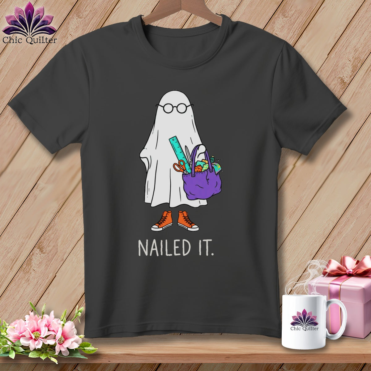 T-shirt graphic of a ghost with glasses, holding a craft bag, wearing sneakers, with "NAILED IT." text.