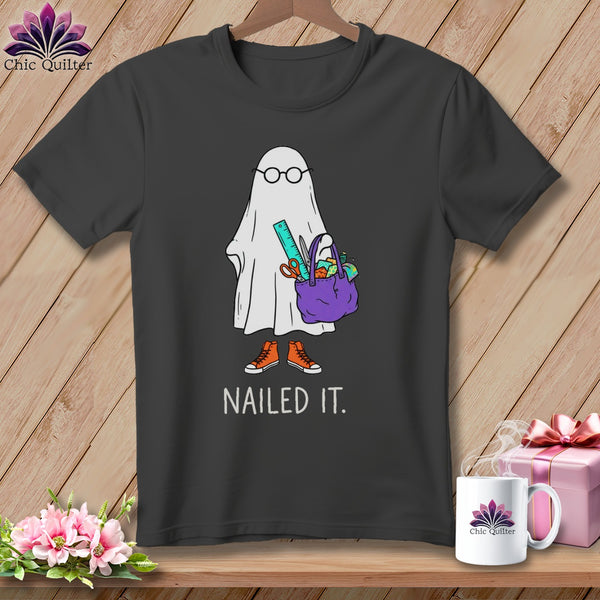 T-shirt graphic of a ghost with glasses, holding a craft bag, wearing sneakers, with "NAILED IT." text.
