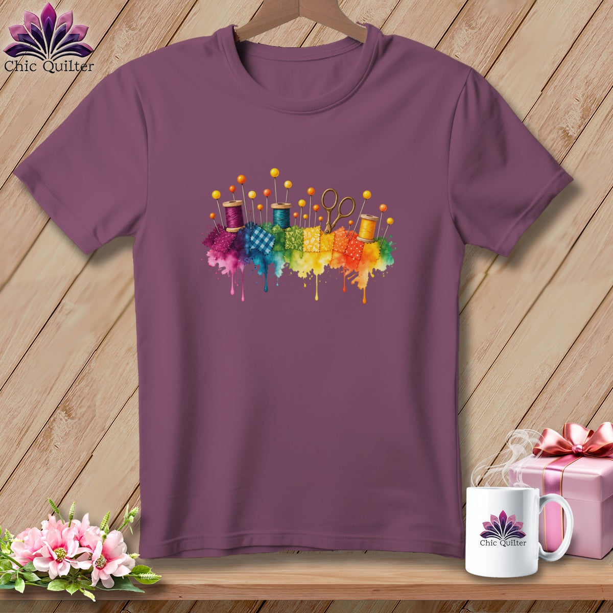 Plum t-shirt with watercolor sewing notions and fabric squares graphic.