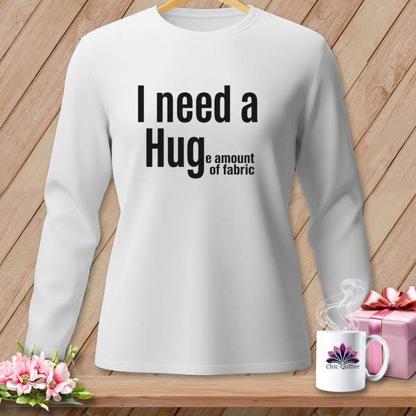 White long-sleeve shirt with text "I need a Hug, the amount of fabric".