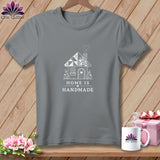 Grey t-shirt with a white graphic of a quilted house and text 