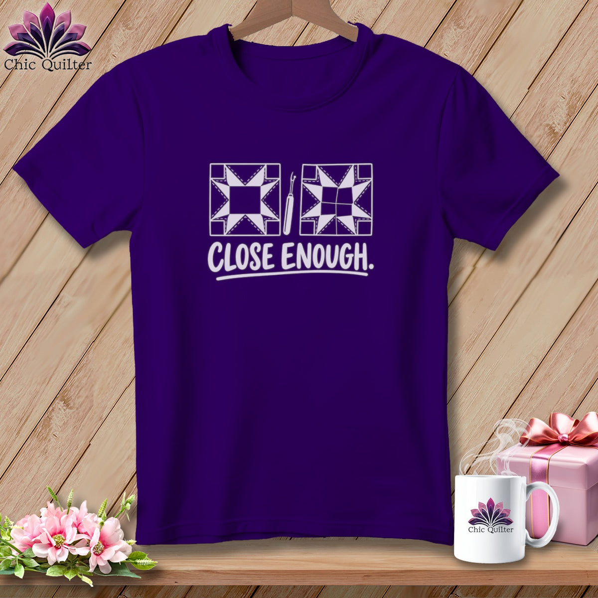 Purple t-shirt with quilting block graphics and "CLOSE ENOUGH." text.