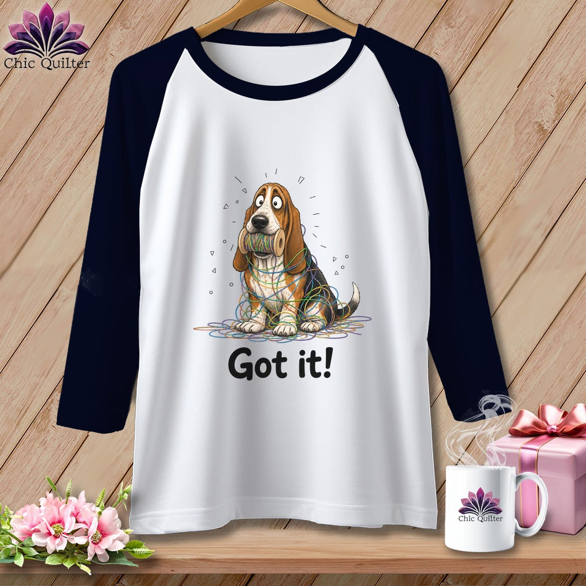 Raglan tee with a Basset Hound entangled in colorful yarn and the text "Got it!".