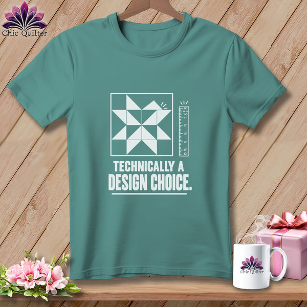 Teal t-shirt with a white quilt block design and text "TECHNICALLY A DESIGN CHOICE."