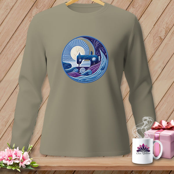 Taupe long-sleeve shirt with circular sewing machine, moon, and water graphic.