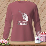 Long sleeve t-shirt with scissors cutting fabric graphic and text.