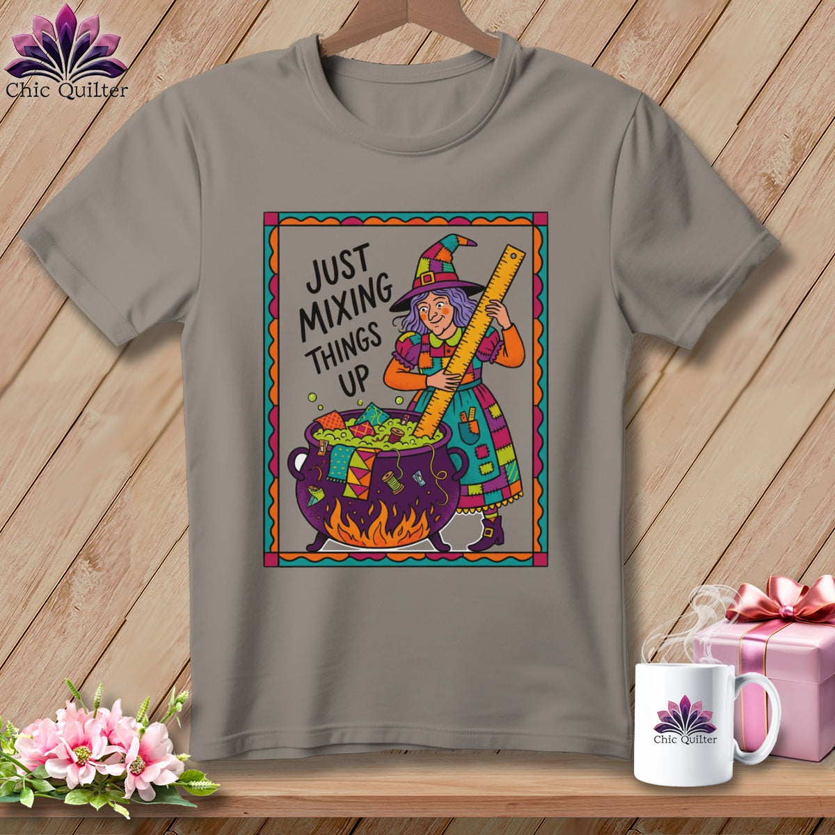 T-shirt with cartoon witch holding a ruler over a cauldron with fabric scraps.