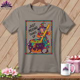 T-shirt with cartoon witch holding a ruler over a cauldron with fabric scraps.