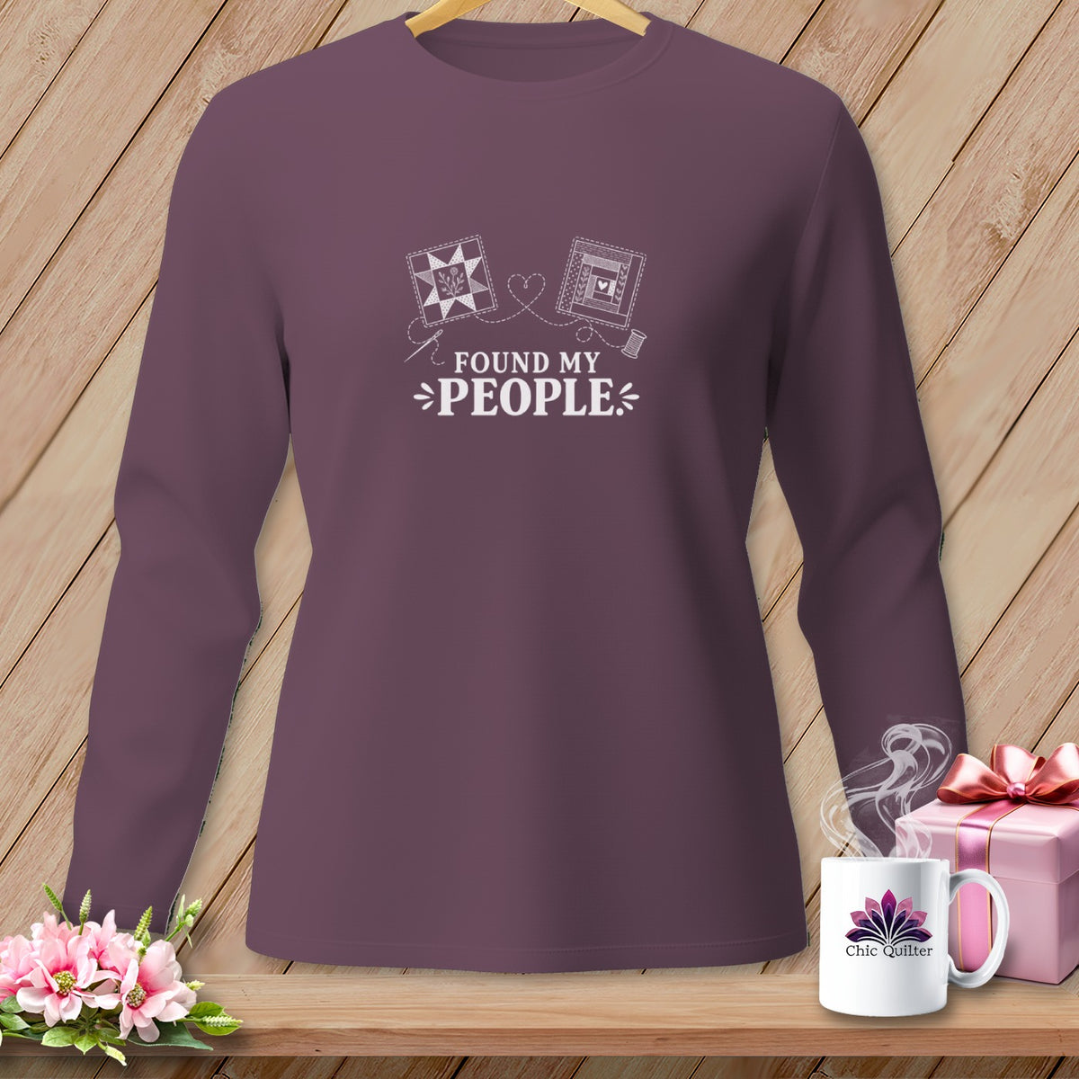 Plum long-sleeve t-shirt with "Found My People" text and quilting motifs.
