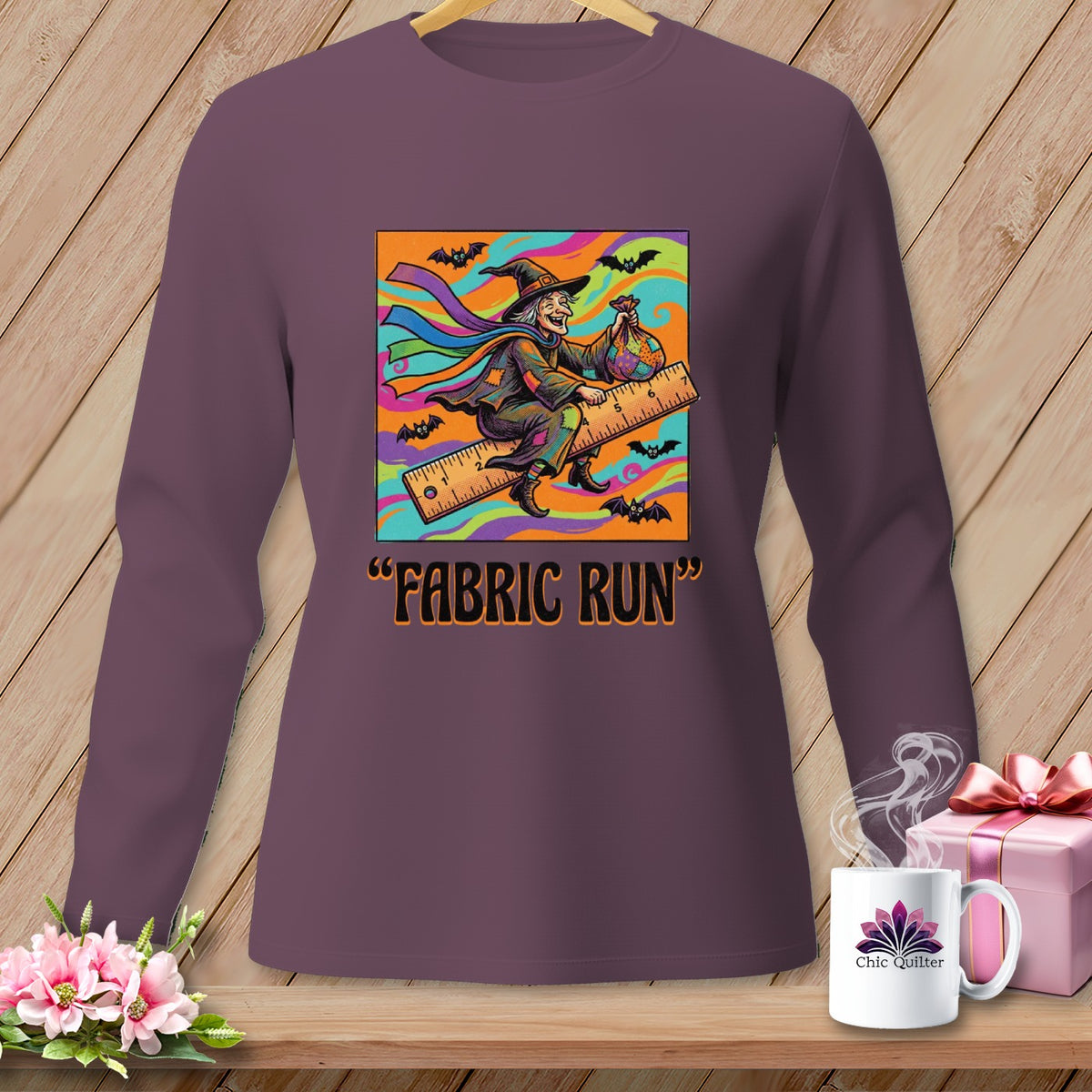 Witch flying on a ruler with a bag of fabric and text "FABRIC RUN".