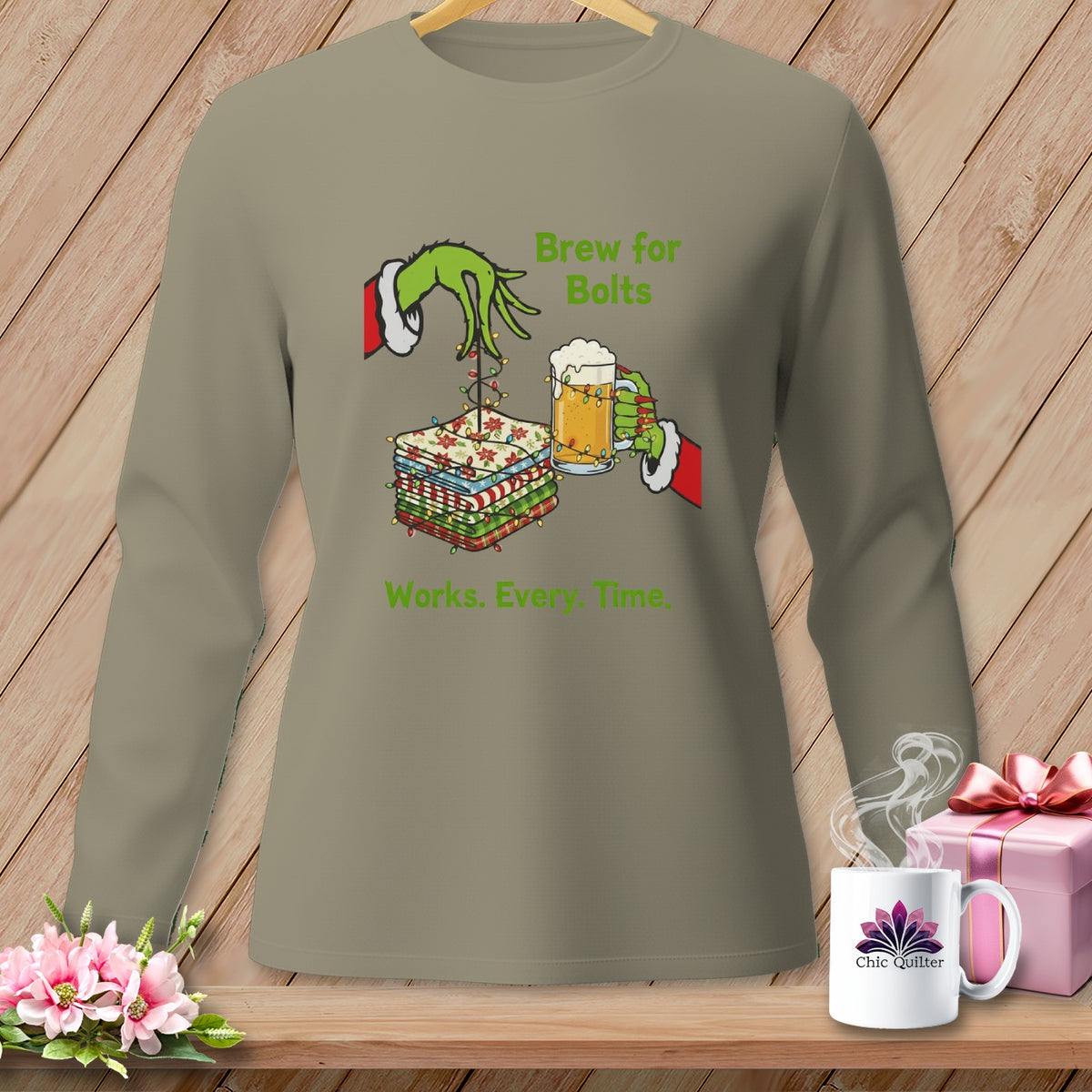 Grinch hands hold fabric stack and beer, with text "Brew for Bolts Works. Every. Time."