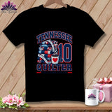 A black t-shirt printed with a Tennessee Quilter graphic featuring a folded quilt and coffee cup.