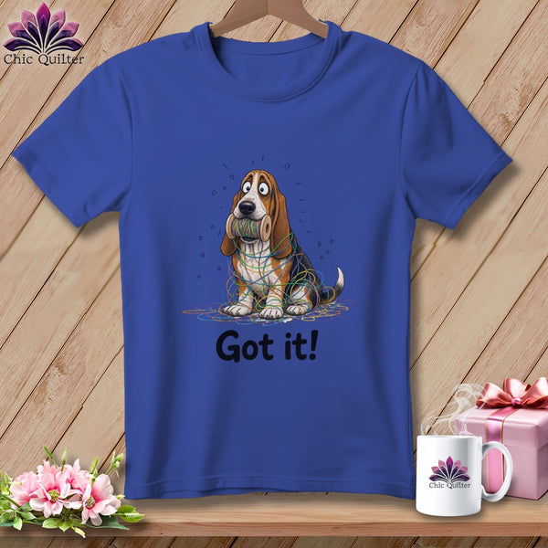 Blue t-shirt with a cartoon Basset Hound tangled in colorful yarn and the text "Got it!".