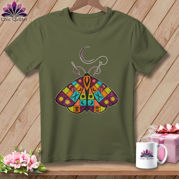 Olive green t-shirt with a colorful patchwork moth graphic and sewing needle.