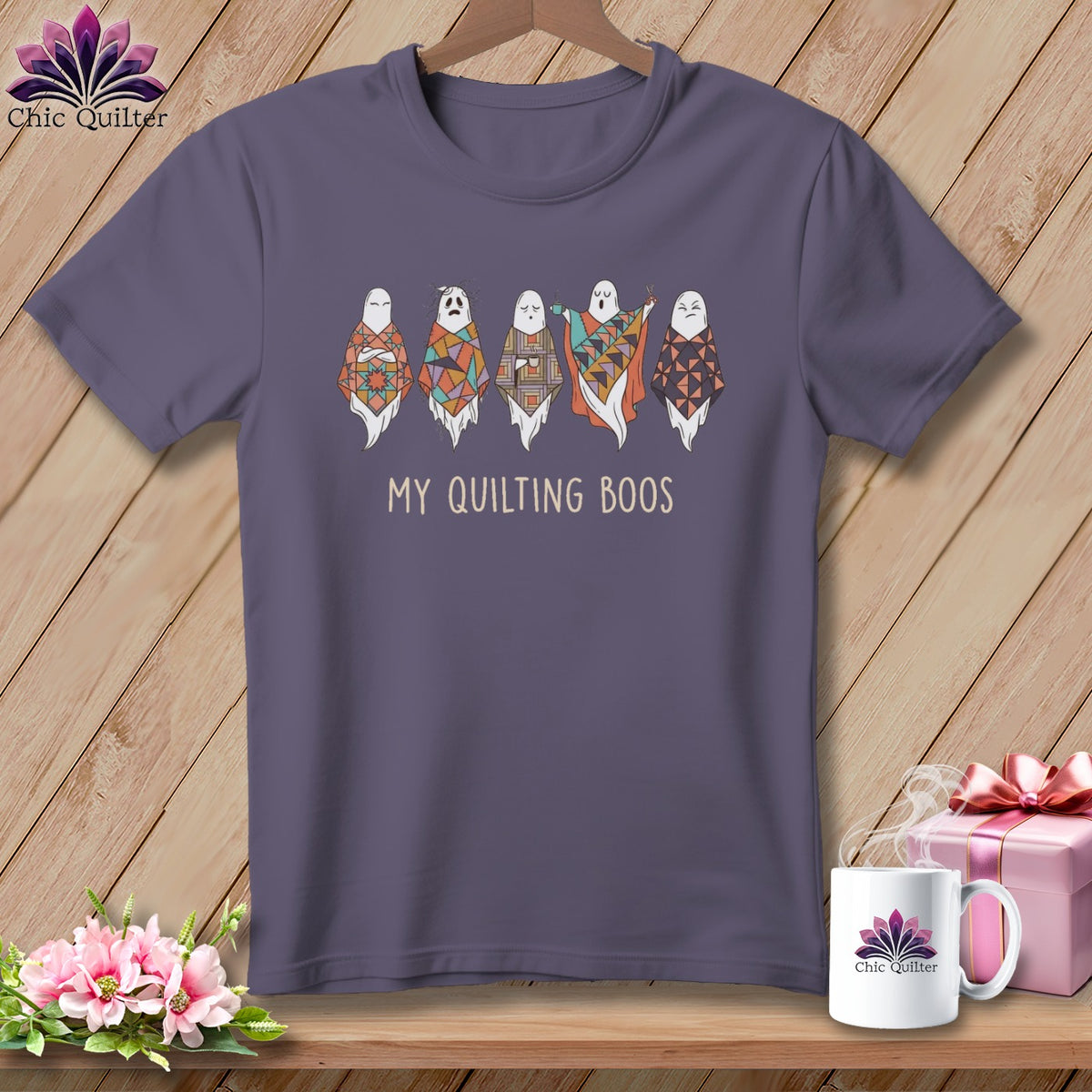 T-shirt with five cartoon ghosts wearing colorful patchwork quilts and the text "MY QUILTING BOOS".