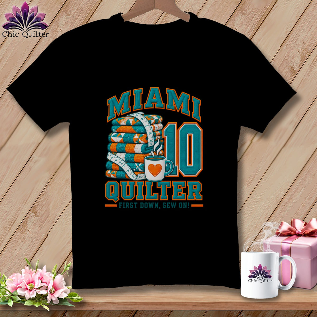 A black t-shirt features a graphic with a stack of quilts, a coffee cup, and the text Miami Quilter First Down, Sew On.