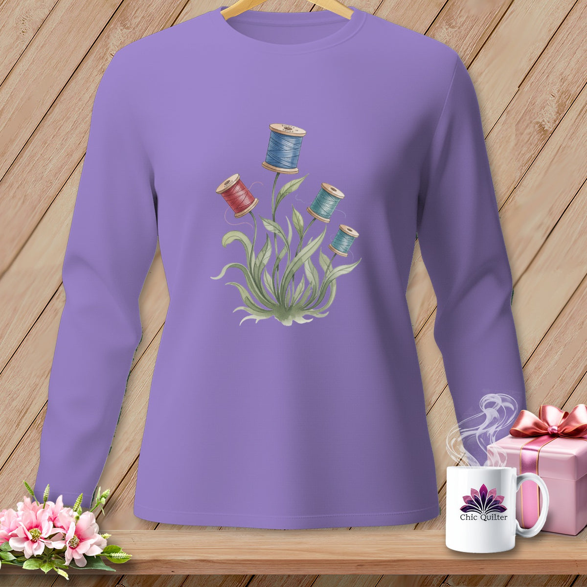 Lavender long-sleeve shirt with spool of thread floral graphic and "Chic Quilter" mug.