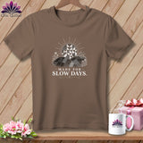 Brown t-shirt with graphic of a quilt-like sun over rolling hills and text 