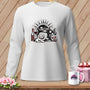 White long-sleeve shirt with a graphic of a dog by a sewing machine, wine, and yarn.